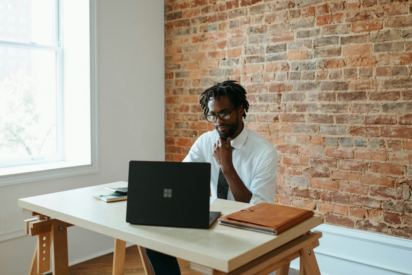 A virtual construction manager observing reports on a laptop.