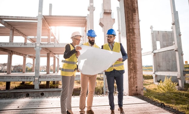 A team of workers looking over a blueprint.