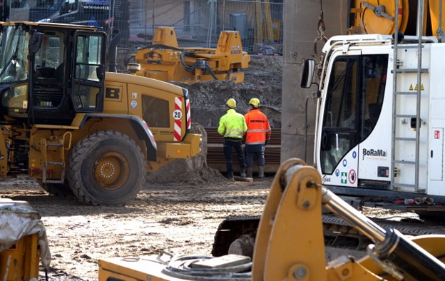 Two workers overseeing a construction project.