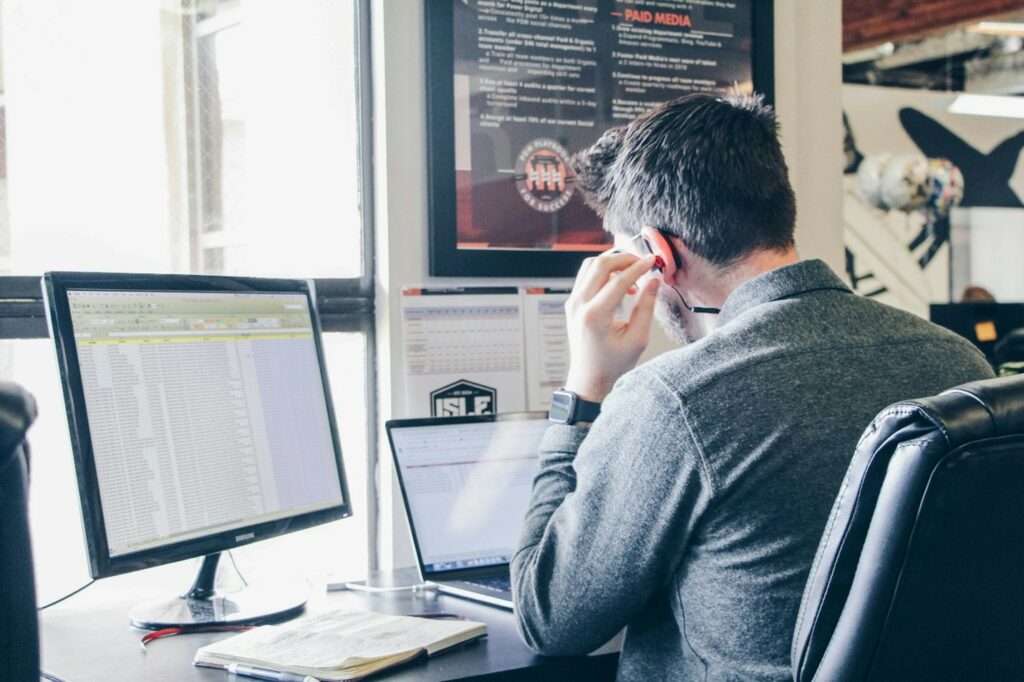 A virtual assistant working with a client at their computer.