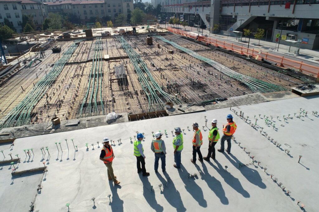 A team of construction workers overlooking a project.