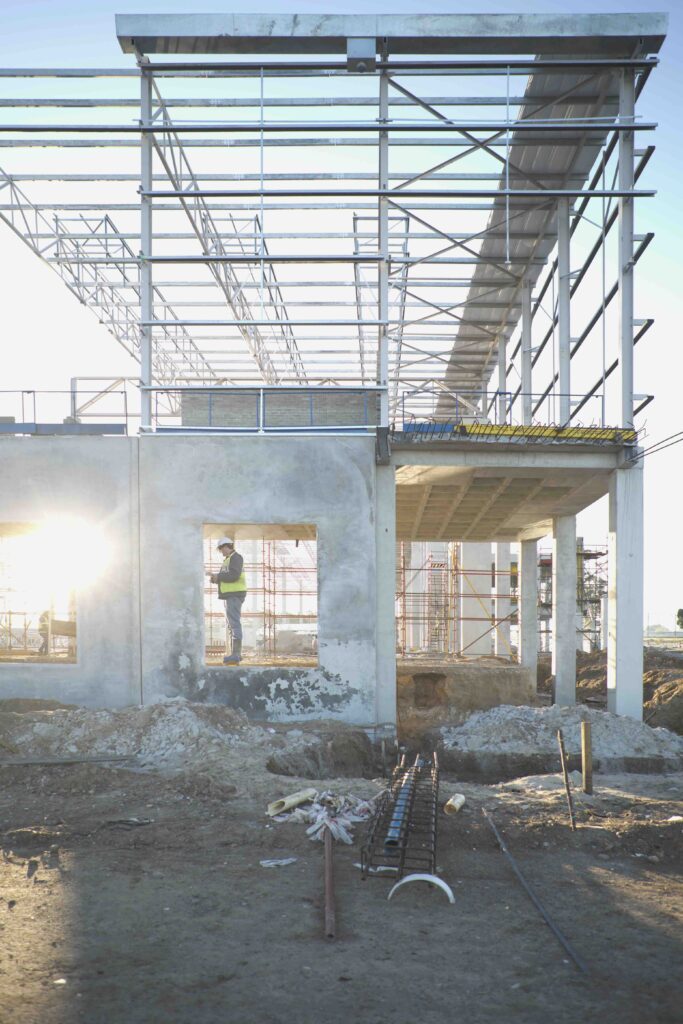 Site manager checking window frame on construction site