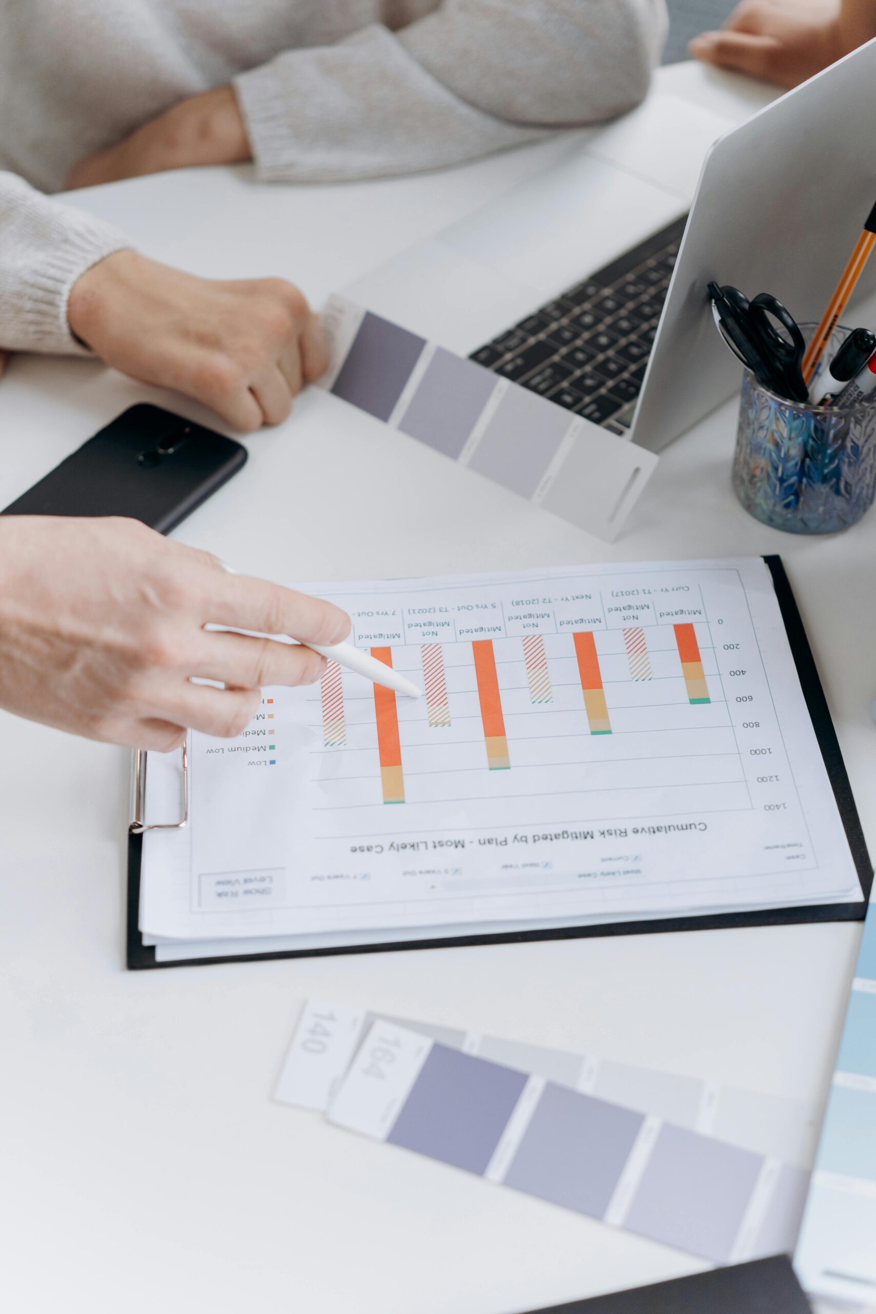 an employer and employee looking over graphs during a performance review