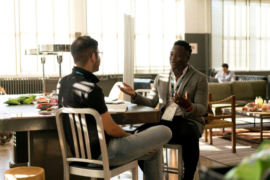 An employer conducting a performance review with one of their team members