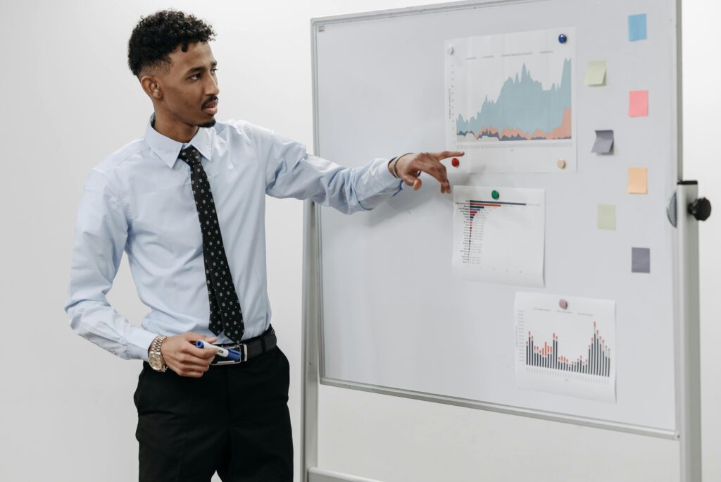 An employer looking over charts and graphs to review individual performance which is a primary purpose of performance reviews