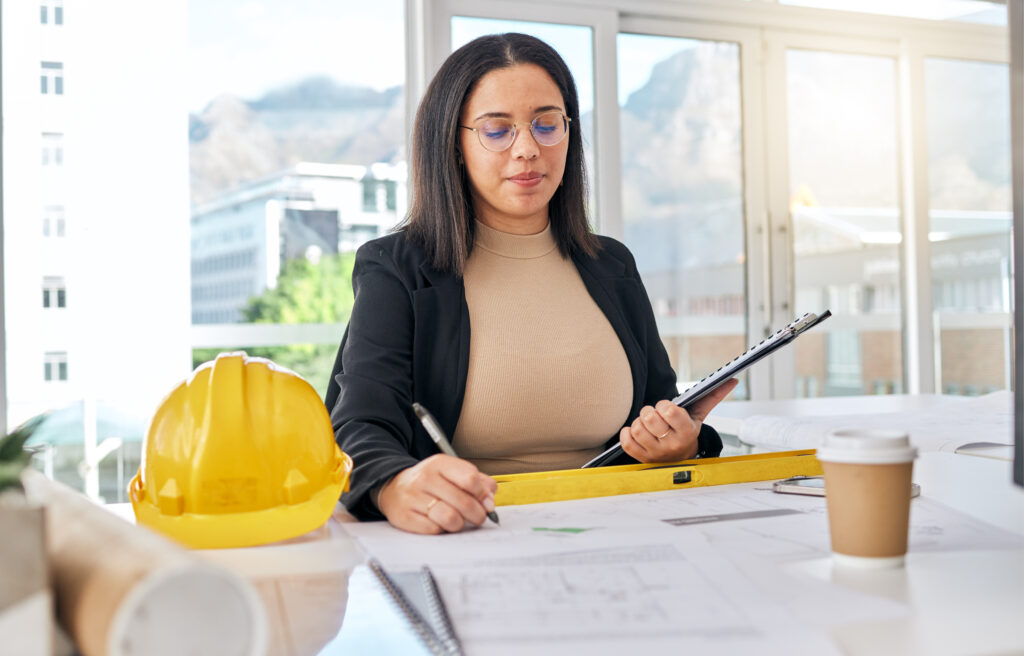 woman working as construction admin assistant writing down in paper