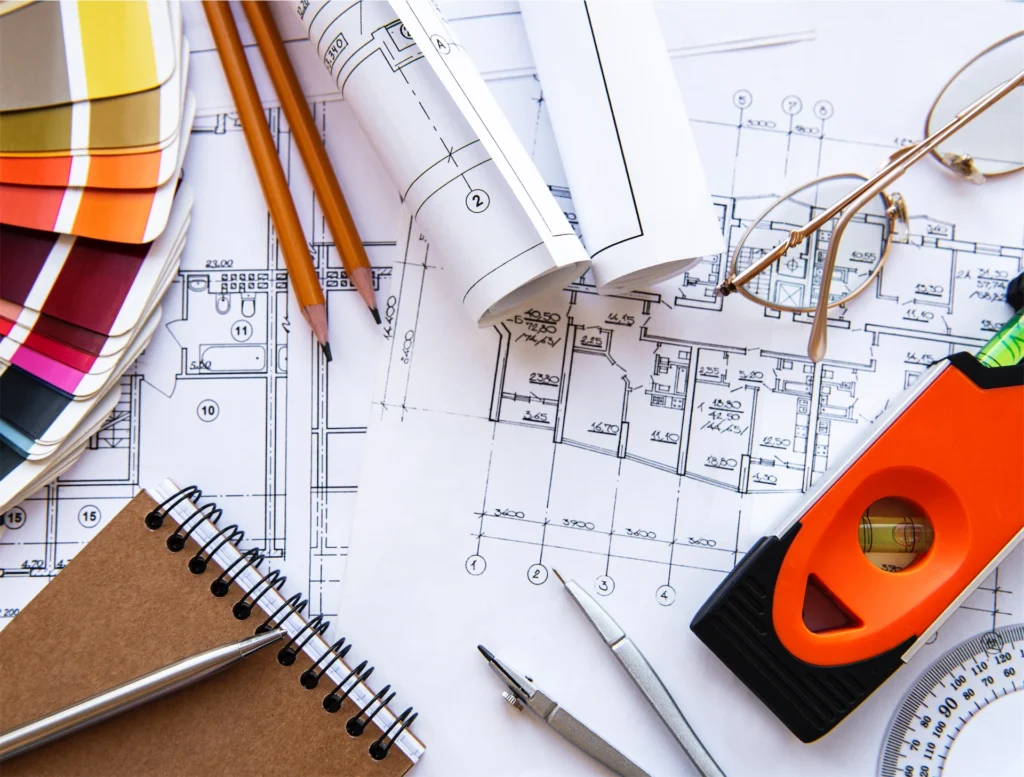 Architectural drawings and tools arranged on design desk