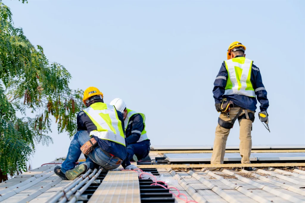 Roofing crew working on tile roof during residential project